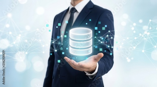 Businessperson managing data through a glowing database icon and complex network structure.