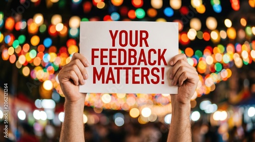 Hands holding sign that says your feedback matters