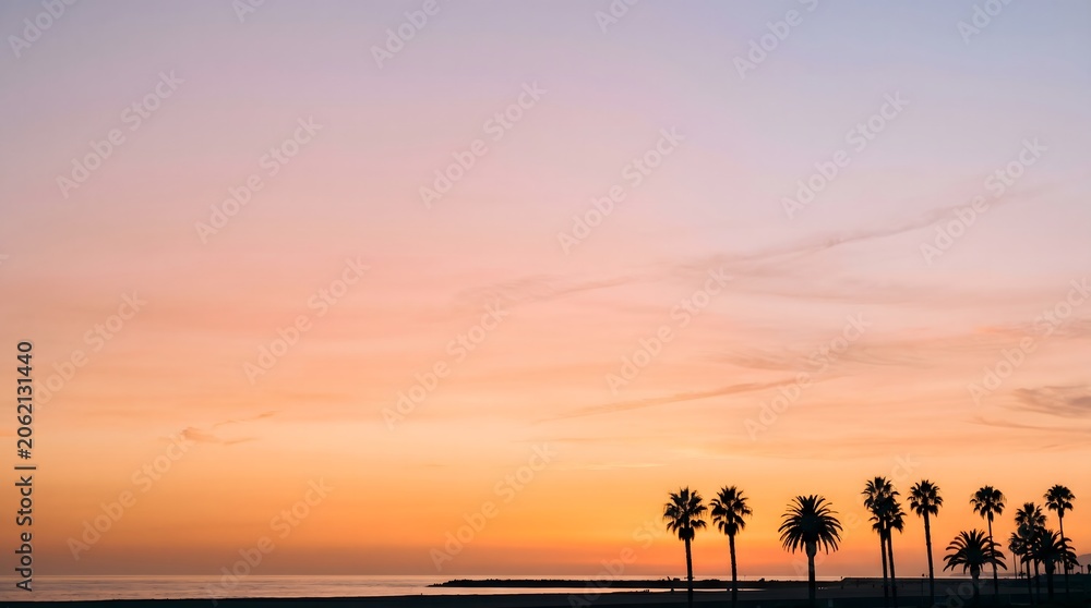 Fototapeta premium Soft Orange Sunset Background with Palm Tree Silhouettes