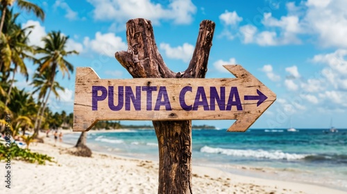Wooden signpost pointing to punta cana on a tropical beach