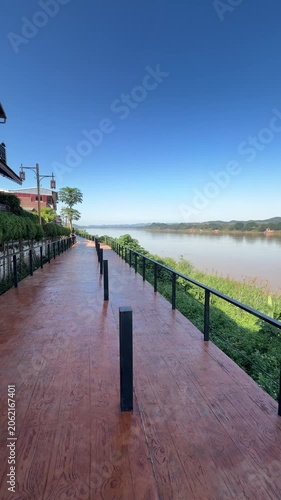Scenic wooden boardwalk along Mekong River in Chiang Khan, Thailand