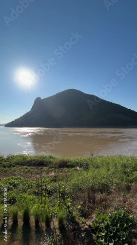 Scenic sunburst over mountain and river landscape