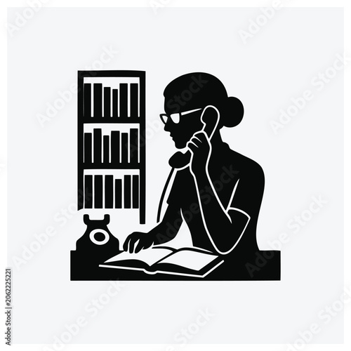 Person consulting books and taking a phone call