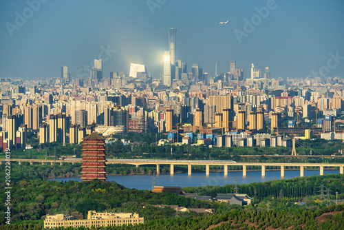 Foto Distant View of Beijing Skyline: Yongding Tower and CBD Skyscrapers with Airplan