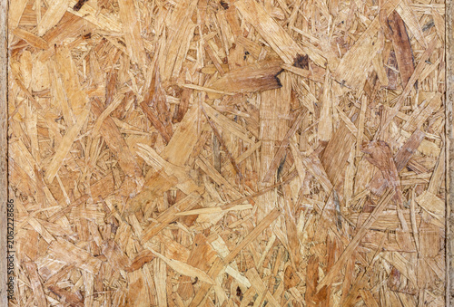 Detailed Texture of Oriented Strand Board for Construction Background. Shot of OSB showing the detailed texture of compressed wooden chips and flakes, ideal for construction or industrial backgrounds.