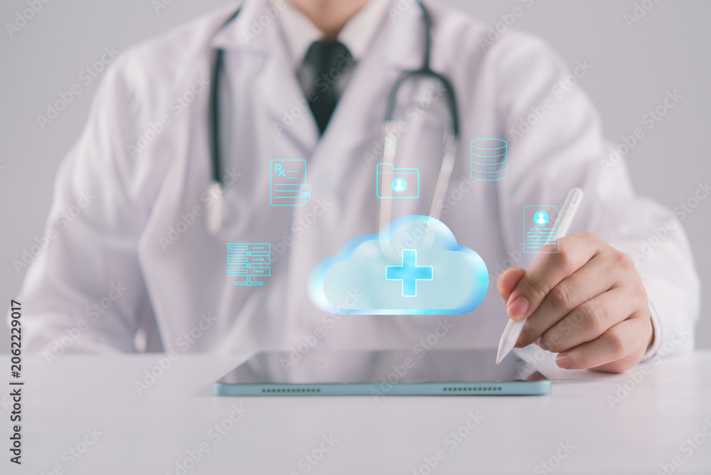 Fototapeta premium Medical cloud computing network hologram on tablet doctor managing patient clinical data storage electronic health record workflow automation and digital transformation in modern hospital
