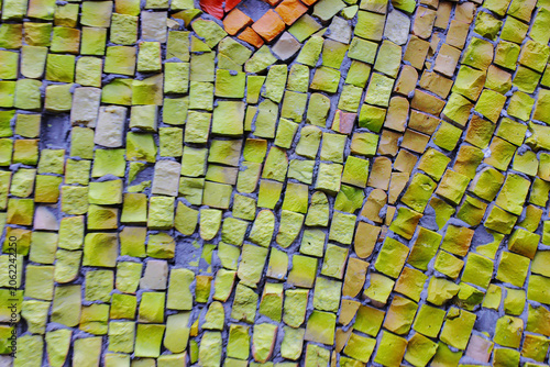 Mosaic tiles glow in warm, textured yellows and earthy tones