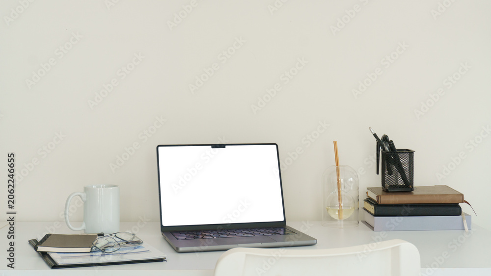 Fototapeta premium Modern laptop mockup on a bright white desk, ideal for website display, online work, digital design, and branding concepts.