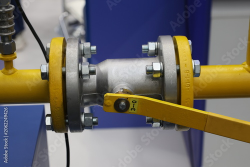Yellow pipe with metal flange and valve handle