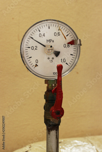 Pressure gauge mounted on industrial pipe