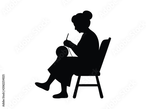 Silhouette of an elderly woman knitting in a chair