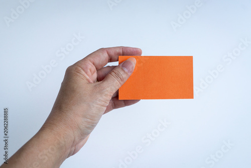 Hand holding an orange blank card.