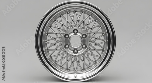 Close-up of a detailed silver wire spoke car wheel rim, showcasing automotive design and engineering.
