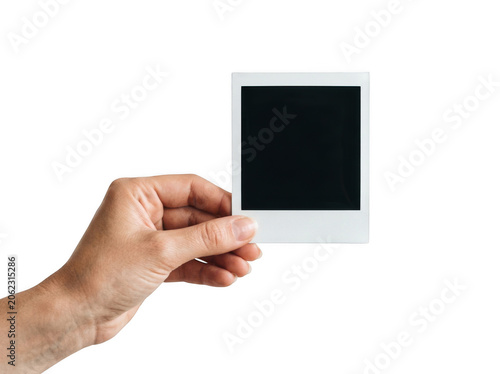 A hand holding a blank polaroid photo frame