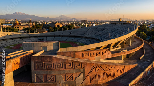 Panoramic view of historic stadium architecture at golden hour with urban cityscape backdrop
