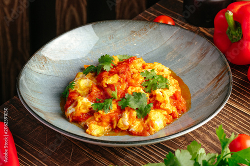 Obraz na plátně Plate of menemen scrambled eggs with fresh cilantro