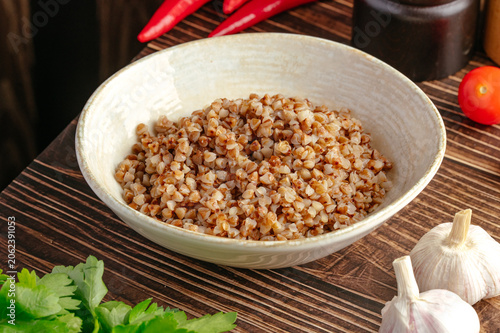 Canvastavla Bowl of cooked buckwheat with fresh vegetables and garlic