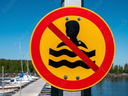 No Swimming Allowed sign posted at harbor outdoors