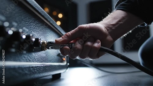 Equipment Setup Demonstrating Connecting Cable to Audio Interface in Dim Studio