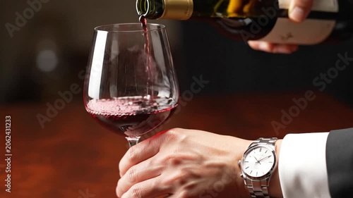 Pouring Red Wine into Glass in Formal Setting