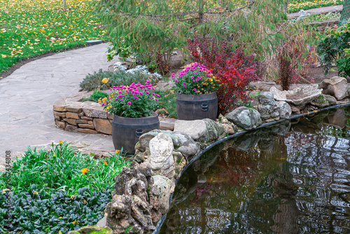 Flowers and stones by the water in a garden path