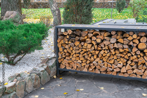 Wood stacked neatly in outdoor area for use