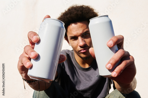 Man holding two cans