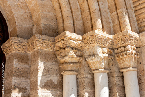 Slika na platnu Detailed view of carved stone capitals and archivolts at the 12th-century Romane