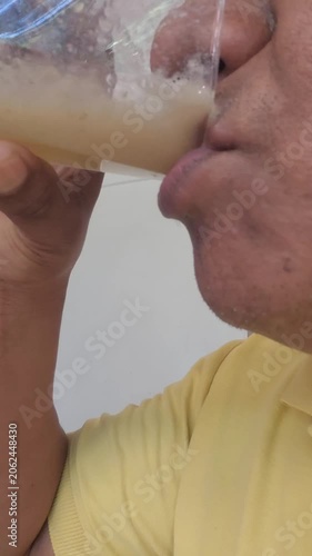 Person Enjoying Homemade Healthy Green Nopal Banana and Apple Smoothie