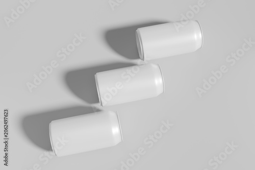 Aluminum beverage cans mockup with three blank white soda can templates, minimalist tin containers for juice or beer branding presentation, top view diagonal layout, realistic 3d render