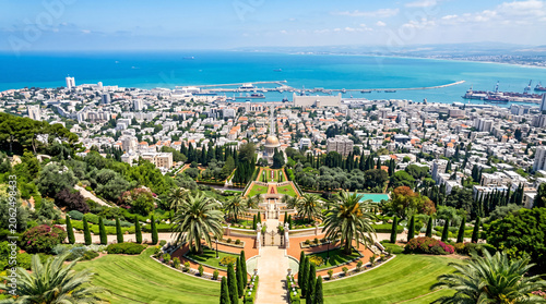 Panoramic coastal city view with terraced gardens, Mediterranean port cityscape under blue sky, scenic urban landscape with lush green park and sea horizon