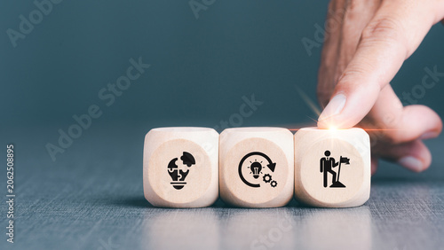 Goal achievement and business success concept. Teamwork, brainstorm new idea, find out solution and strategy planning to improve, develop business. Businessman holds wooden cubes with 