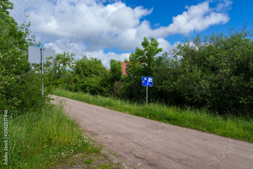 rural street in a residential area with a sign