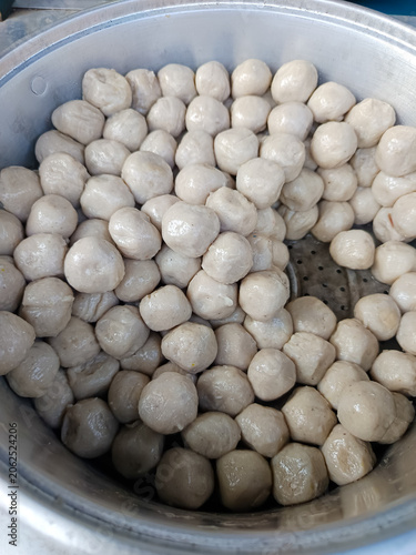 Slika na platnu Fresh steamed fish balls in a large metal steamer tray, traditional street food