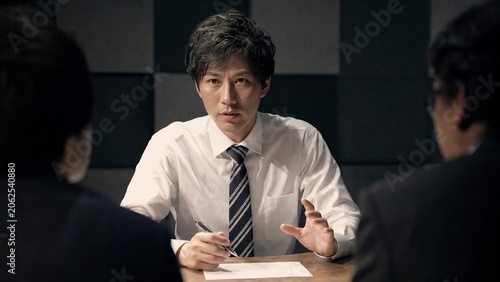 Professional Businessman Explaining Ideas During Meeting with Colleagues