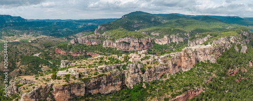 Close aerial view of Siurana village perched on towering sandstone cliffs in Catalonia, Spain.