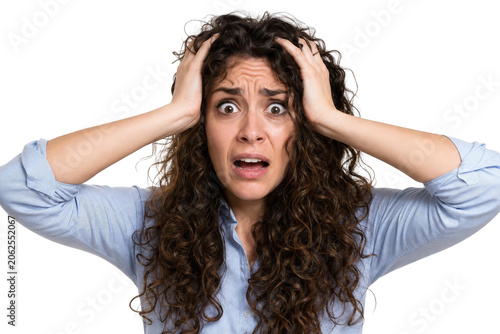 Stressed Young Woman in Panic Holding Her Head Isolated on White