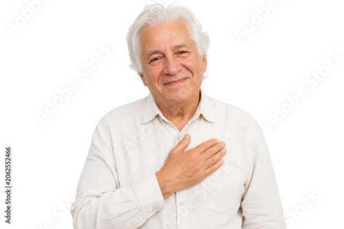Sincere Senior Man Smiling with Hand on Chest Expressing Gratitude Isolated on White