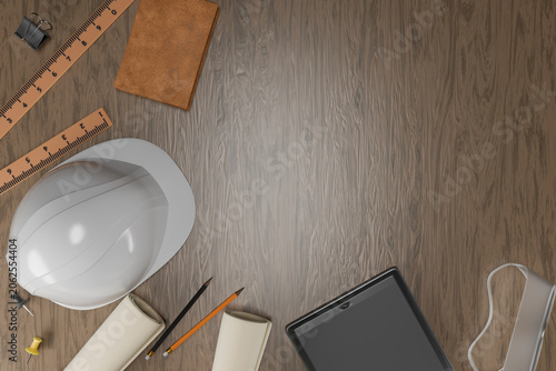 Engineer desk flat lay with white hard hat, digital tablet and blueprints.