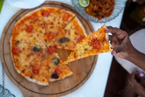 Pizza restaurant cafe model food lifestyle showcasing gourmet pizza dining modern cafe atmosphere and relaxed hospitality experience in Tanzania
