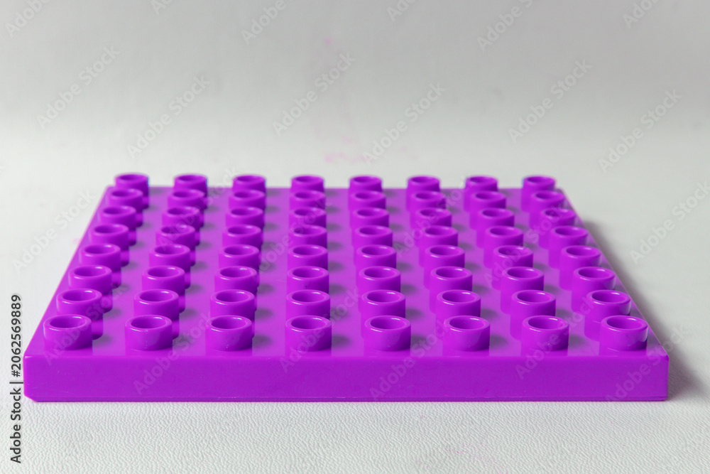 Naklejka premium Salatiga, Indonesia - June 18, 2026: Front Perspective view Bright Purple Square lego duplo base plate toy block brick isolated on white