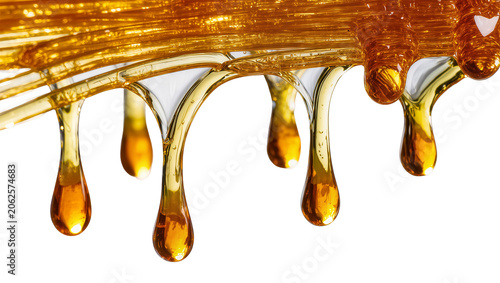 Photos Golden viscous liquid dripping in drops, close-up macro shot