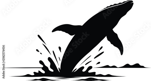 Majestic black silhouette of a breaching whale jumping from the ocean water with dramatic splashes