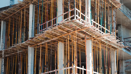 Foto Concrete formwork and metal shoring props at construction site closeup