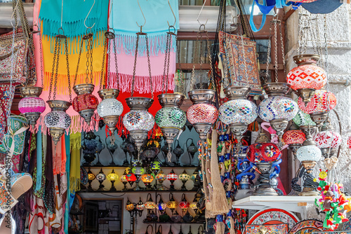 Tableau sur toile Traditional mosaic lanterns hang among bright textiles and handmade souvenirs in a colorful market shop, Mostar, Bosnia and Herzegovina