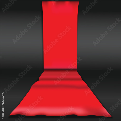 Fotografie Red carpet unrolling on black background for VIP awards ceremony or movie premie