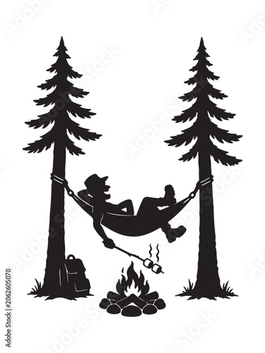 Man relaxing in hammock between trees by campfire
