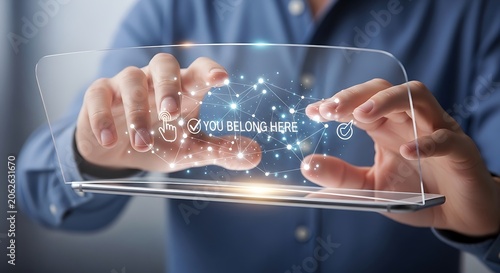 Man Interacting with Futuristic Transparent Device Displaying You Belong Here Message.