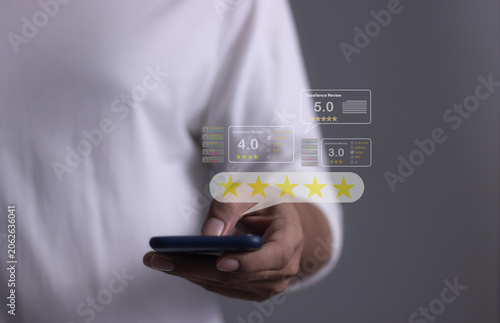 Customer Review, Young Man hand holding Smart Phone with five star to review and give 5 stars with very good results in service, Good review 5 star rating choice feedback