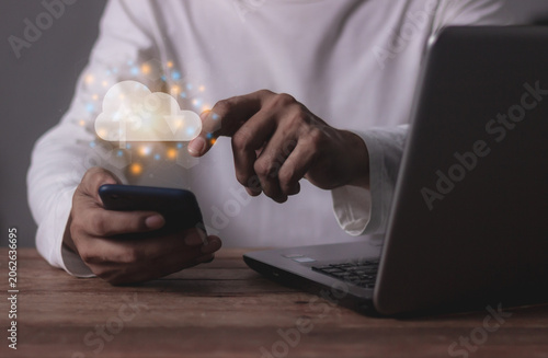 Young man with computer notebook and smartphone mobile hand touching to cloud computing diagram, Data storage, Cloud technology, Cloud Computing Storage